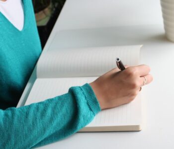 A therapist writing at a desk, representing the path to Brainspotting certification