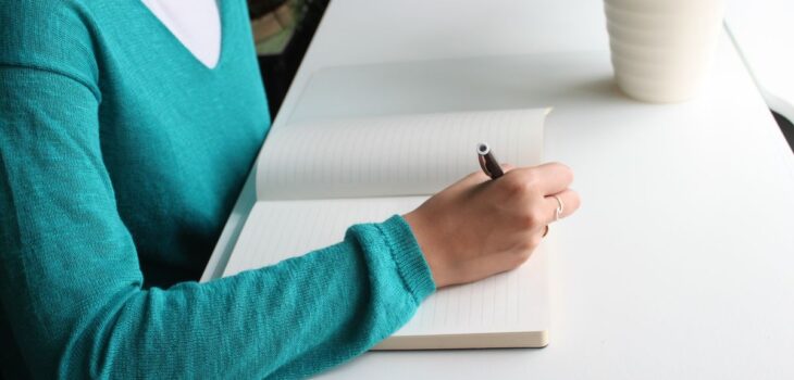 A therapist writing at a desk, representing the path to Brainspotting certification